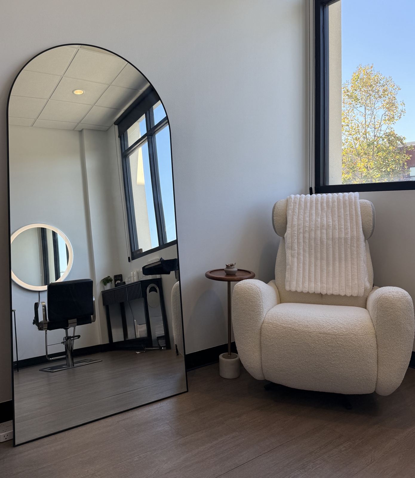 Remodeled styling station with round lit mirror at Hue Boutique Salon, Alameda, CA, 2690 5th St.