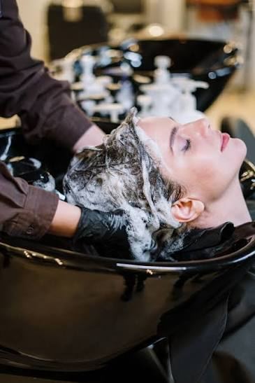 Client receiving a shampoo service at Hue Boutique Salon in Alameda, CA